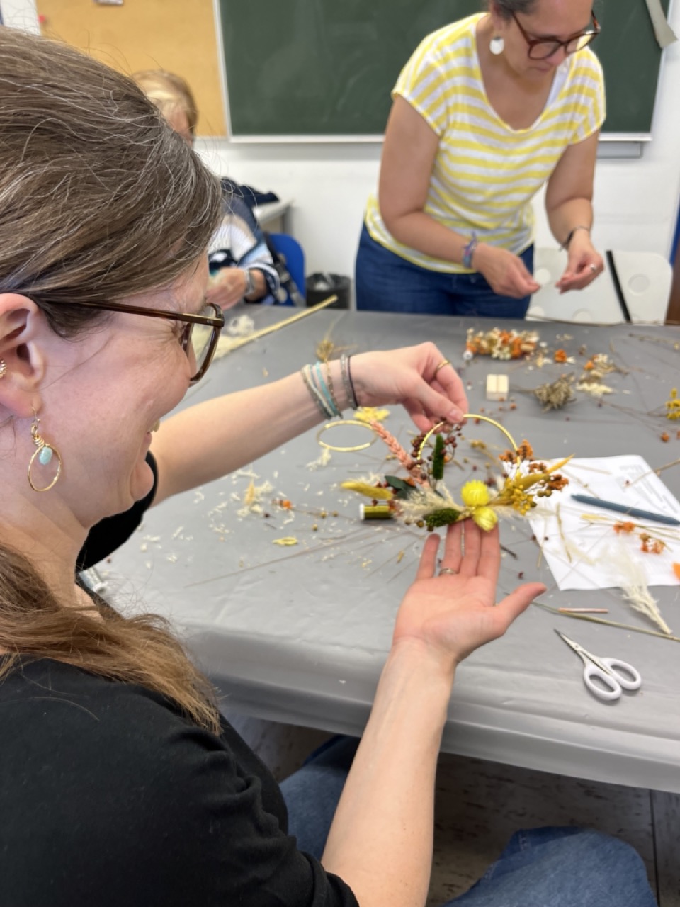 Teilnehmerin Trockenblumenworkshop Teilnehmerin zeigt ihren Trockenblumenkranz